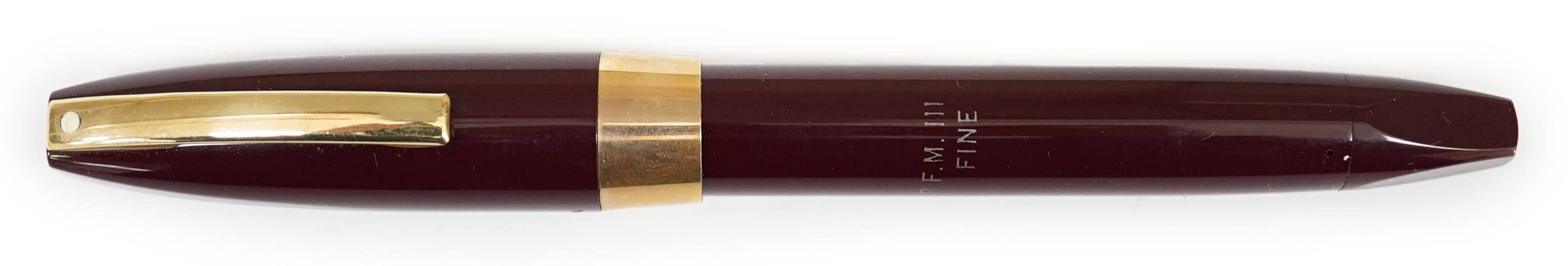 A Sheaffer PFM fountain pen in burgundy, with factory chalk marks to barrel